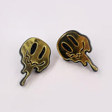 Melted happy face earring